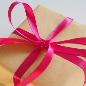 brown gift box with pink ribbon